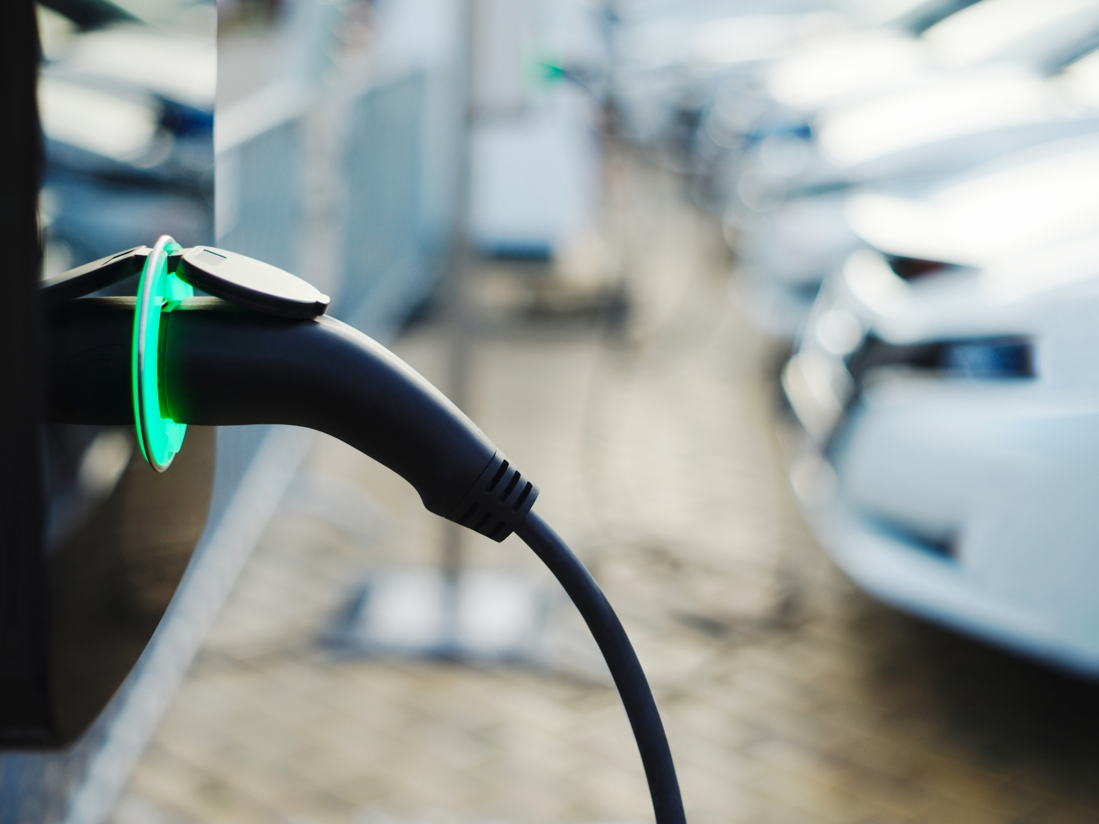 De kabel van een elektrische auto hangt in de laadpaal.